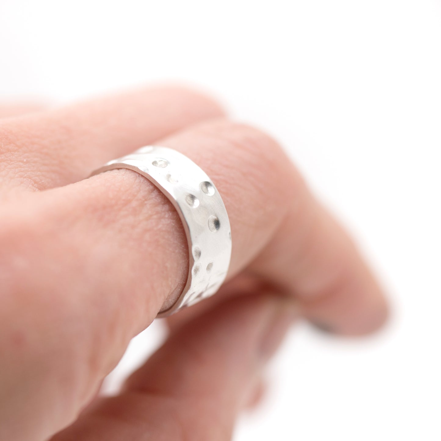 Fine silver band ring with a richly hammered, matte surface on a white background_MorphiArtForge_Handcrafted Jewelry