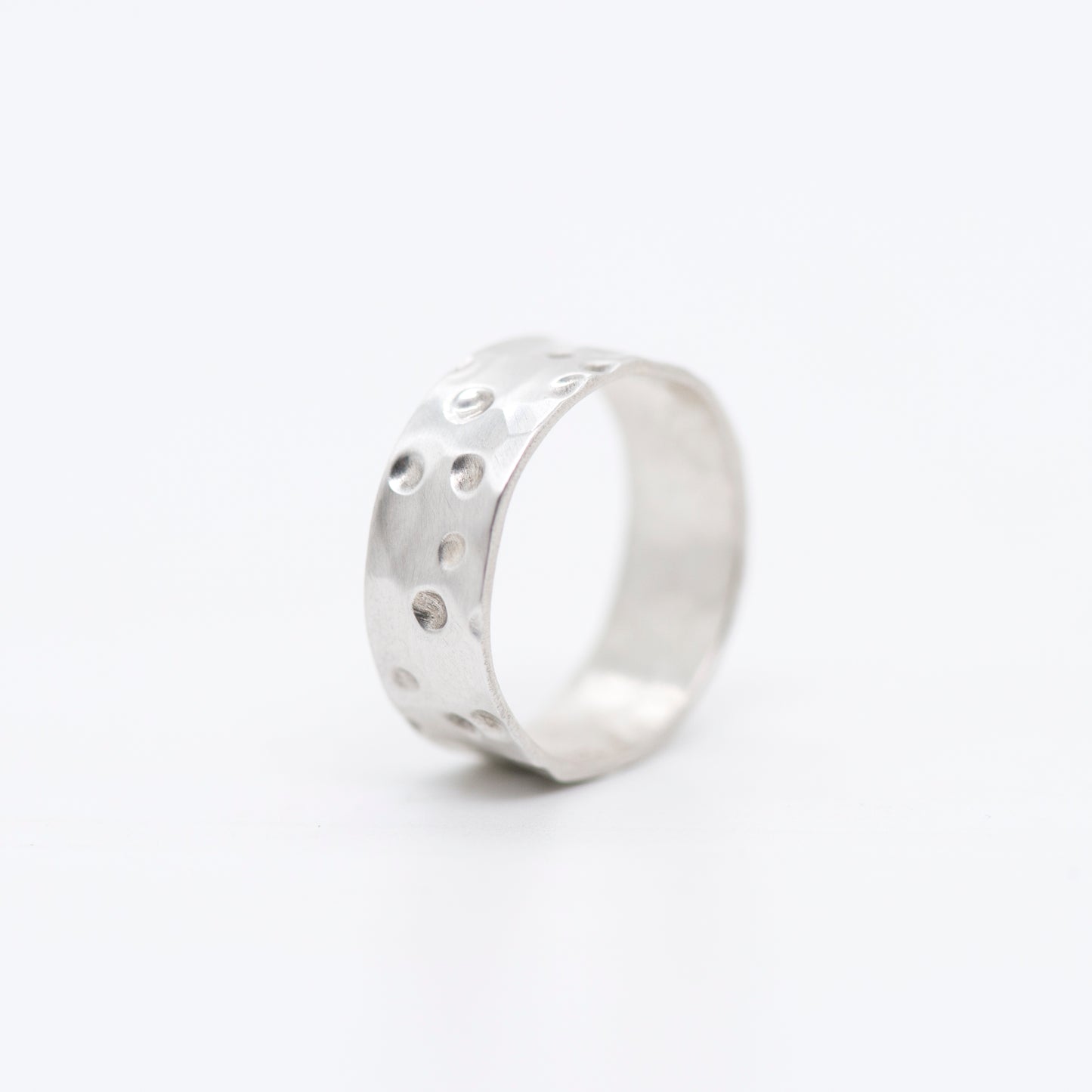 Fine silver band ring with a richly hammered, matte surface on a white background_MorphiArtForge_Handcrafted Jewelry