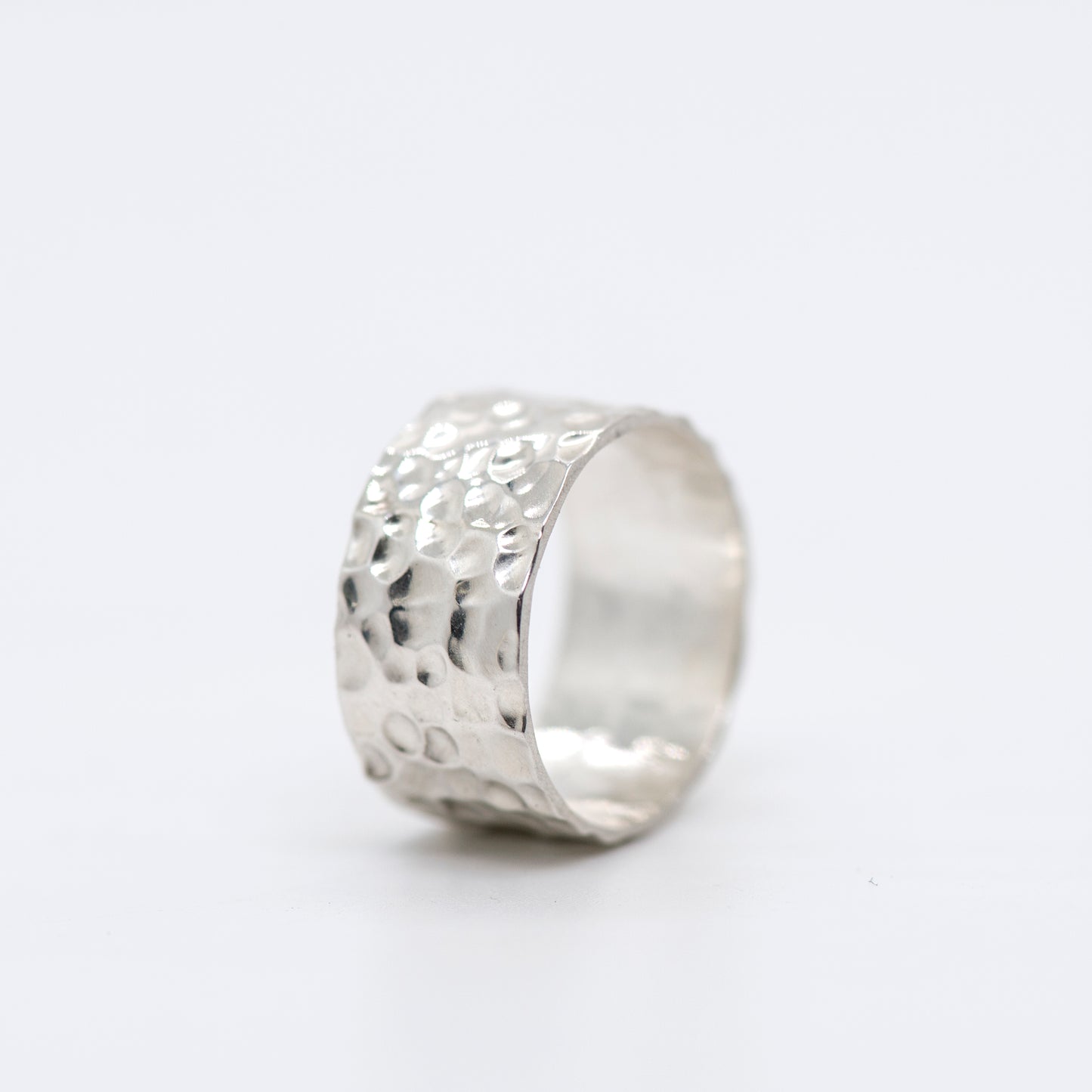 Fine silver band ring with a richly hammered, matte surface on a white background_MorphiArtForge_Handcrafted Jewelry